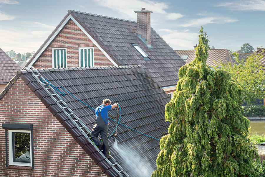 man cleans the roof